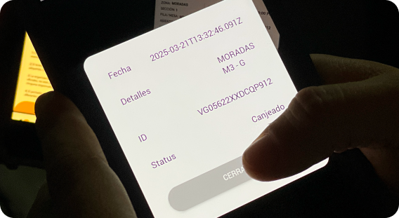 Phone validating a QR ticket next to a printed ticket